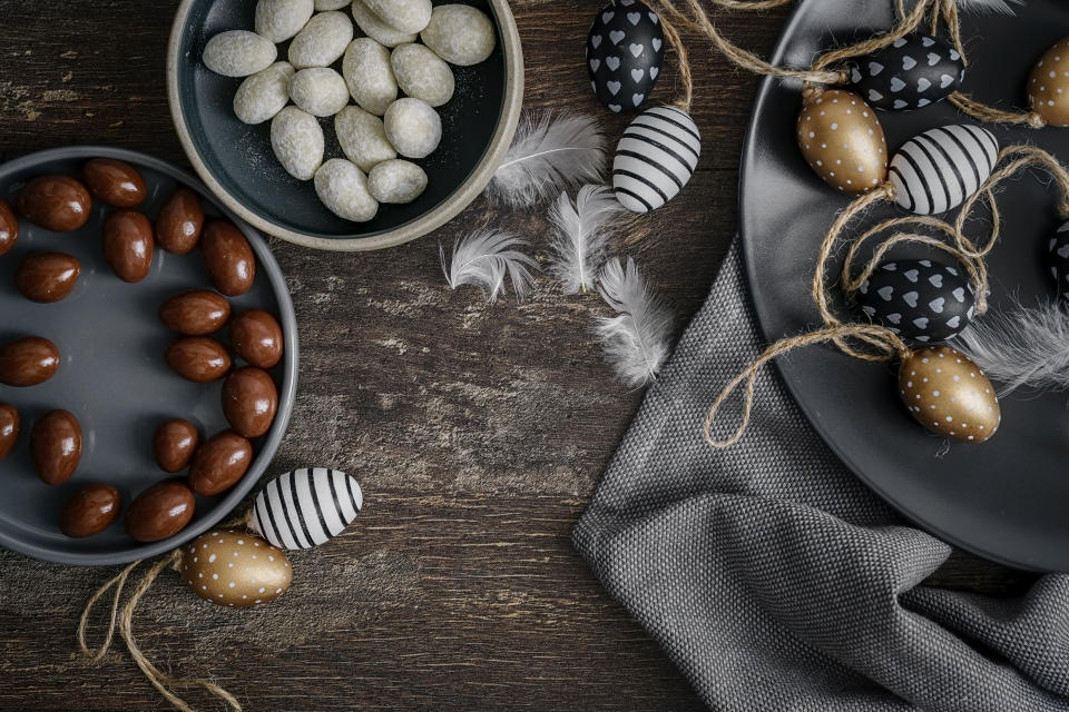 Kiel, Schleswig Holstein, Germany - mars 26, 2019 : Black and white chocolate eggs on a dark wooden background.