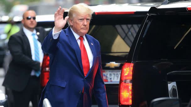 PHOTO: Former President Donald Trump waves while walking to a vehicle in New York City on Aug. 10, 2022. (Stringer/AFP via Getty Images)