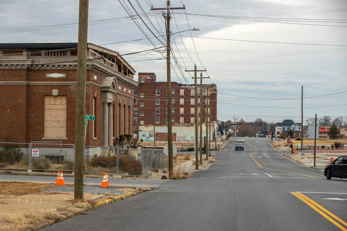 A year later looking down West Broadway, a fence has been erected around the former post office in downtown Mayfield, Ky. Sunday, Dec. 4, 2022