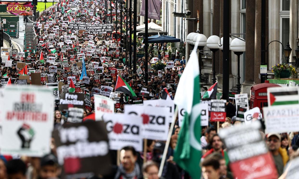 <span> People take part in a 'March For Palestine' in London in October 2023. Thousands of people have been regularly protesting on the streets of London against the bombardment of Gaza by Israeli forces.</span><span>Photograph: Henry Nicholls/AFP/Getty Images</span>