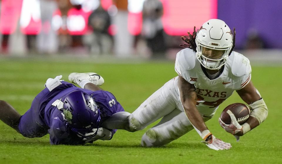 Texas Longhorns running back Jonathon Brooks (24) is pulled down by TCU Horned Frogs safety Mark Perry (3) late in the fourth quarter of an NCAA college football game, Saturday, November. 11, 2023, at Amon G. Carter Stadium in Fort Worth, Texas. Texas Longhorns running back Jonathon Brooks (24) did not return to the game after lipping off the field. Texas Longhorns won 29-26 over TCU Horned Frogs.