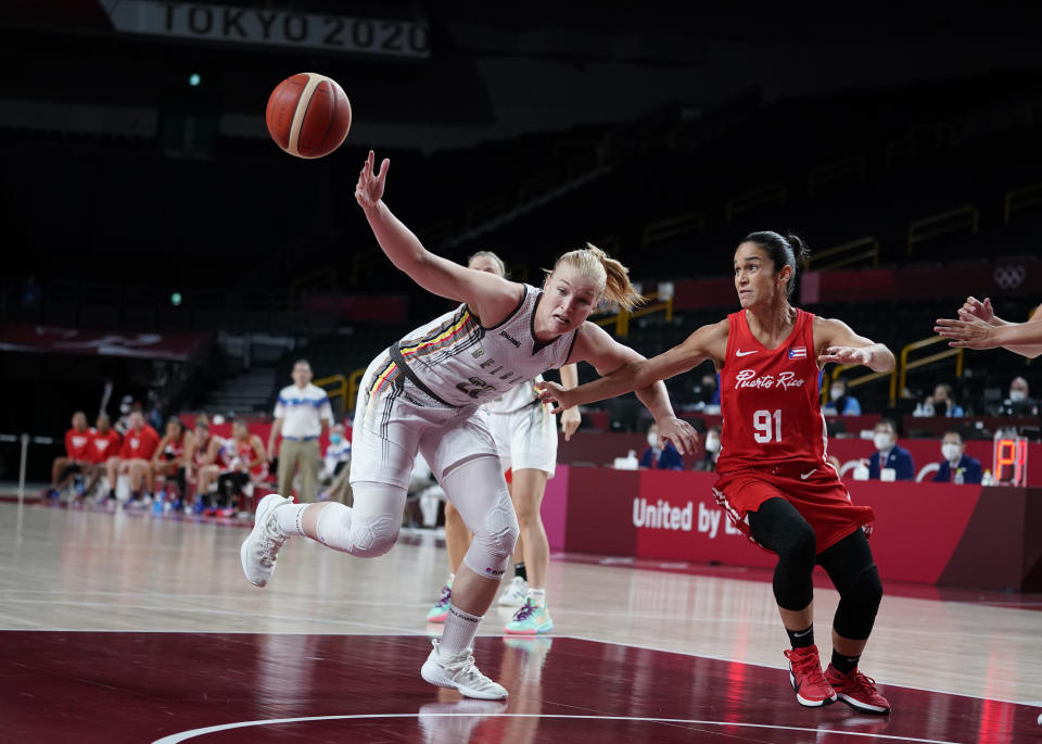 Belgium's Hanne Mestdagh (22), left, and Puerto Rico's Michelle Gonzalez (91) fight for the ball during women's basketball preliminary round game at the 2020 Summer Olympics, Friday, July 30, 2021, in Saitama, Japan. (AP Photo/Charlie Neibergall)