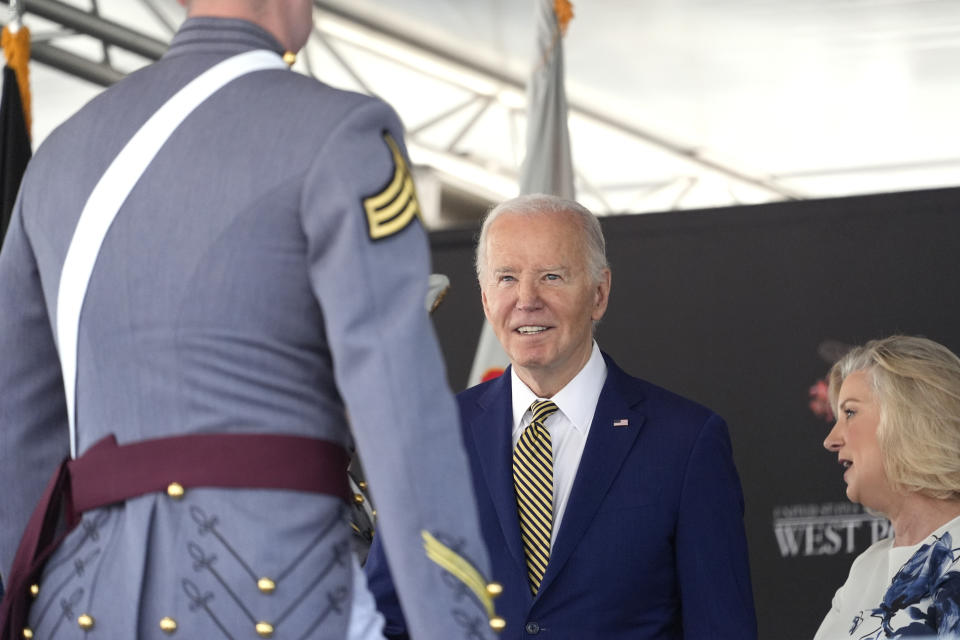 President Joe Biden, center, presents diplomas to graduating cadets at the U.S. Military Academy commencement ceremony, Saturday, May 25, 2024, in West Point, N.Y. (AP Photo/Alex Brandon)