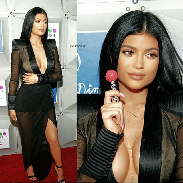 Who knew Kylie Jenner was so punny? The <em>Keeping Up with the Kardashian</em> star was very aware that people were paying attention to the plunging frock she wore to the opening of a new Sugar Factory in Miami more than the sweet treats inside the South Beach store. "There's a lot of duct tape under this dress holding these suckers up," the 17-year-old wrote on a Instagram post she's since taken down. <strong>WATCH: Kylie Says She's Been 'Bullied By The Whole World'</strong> From the curve-hugging fabric to the revealing cleavage, the partially see-through black satin dress channeled big sister Kim Kardashian more than Kylie ever has before. If the blinged-out lollipop seems out of place paired with Kylie's attention-grabbing look, think again -- the sweet treat is a Kylie & Kendall Black Diamond Couture Pop (naturally) that's sold at Sugar Factory. Kylie documented more than just last night's red carpet -- her trip to Miami was plastered all over Instagram. First we got to check out the teen's sneaker and luggage game: <strong>PHOTOS: Kylie Models Tyga's Underwear on Snapchat</strong> Next came the airplane selfie: It turns out Kylie doesn't cake on makeup for trips to the airport, which was a very different look from her usual pouty-lipped pics: Then we saw what Kylie's abs looked like en route to the Versace pool. Because when on a working vacation, you know? Kylie wasn't focused solely on Instagram this week -- she also took to Snapchat to reveal that she's felt bullied her entire life. Find out why in the video below.