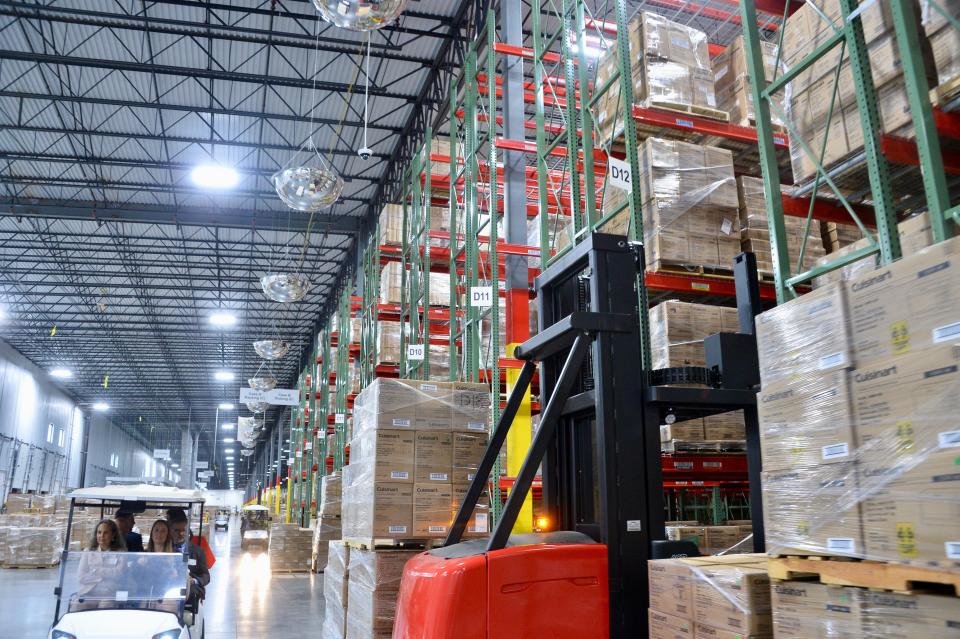 Some of the many tall racks of pallets inside the new Conair distribution center southwest of Hagerstown. Visiting officials and media toured the facility via golf carts.