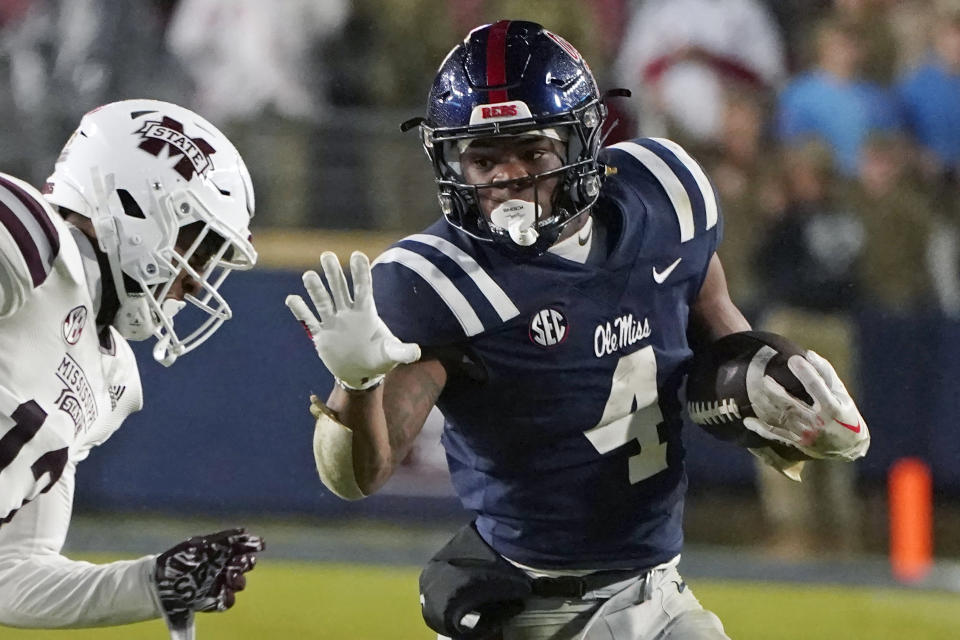 FILE - Mississippi running back Quinshon Judkins (4) looks to fend off Mississippi State safety Shawn Preston Jr. (12) during the second half of an NCAA college football game in Oxford, Miss., Thursday, Nov. 24, 2022. Ole Miss looks to end a disappointing season on a positive note Wednesday night, Dec. 28, 2022 when the Rebels meet Texas Tech in the Texas Bowl. (AP Photo/Rogelio V. Solis, File)