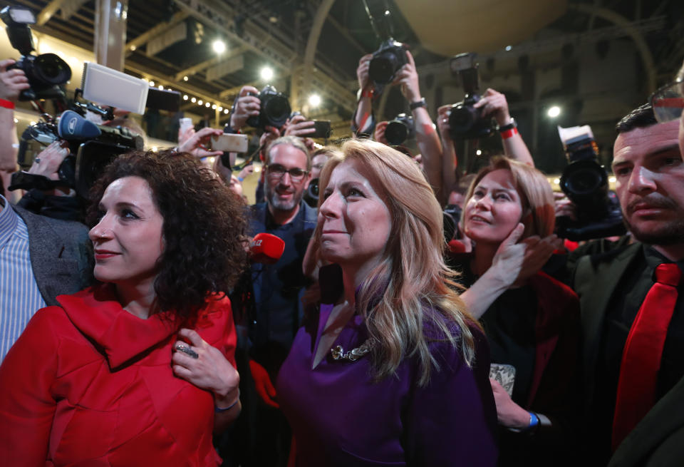 Presidential candidate Zuzana Caputova watches on screen the first preliminary results of the second round of the presidential election in Bratislava, Slovakia, Saturday, March 30, 2019. Voting has ended in the runoff of Slovakia's presidential election, and early results show a favorite female candidate in a lead. (AP Photo/Petr David Josek)