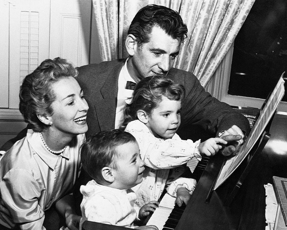 Leonard Bernstein, Felicia Montealegre and their two children at a piano