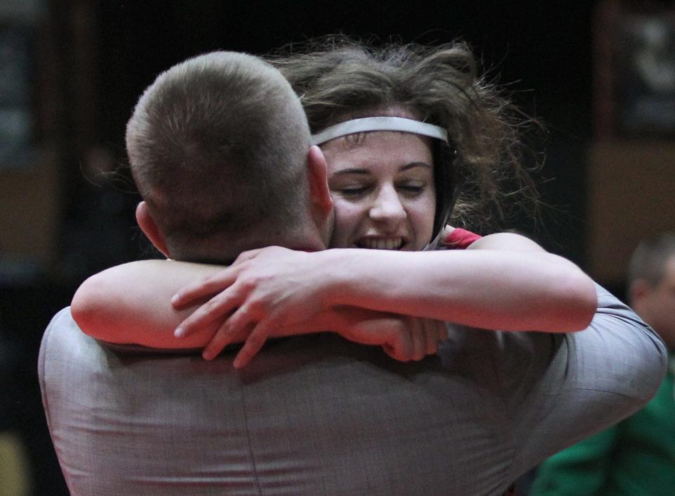 Rossville&#39;s Kendra Hurla hugs her coach Courtney Horgan after defeating Pratt&#39;s Jadyn Thompson in the championship match of the 120-pound weight class at the state wrestling championship Thursday in Salina.