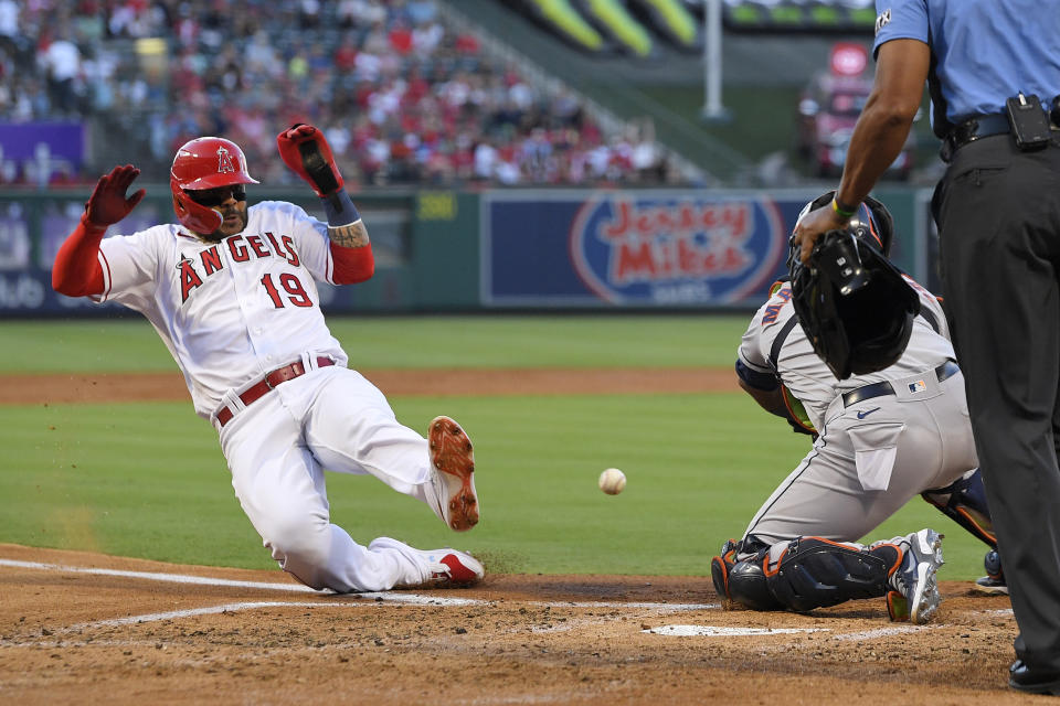 Los Angeles Angels' Jonathan Villar, left, scores on a single by Brandon Marsh as Houston Astros catcher Martin Maldonado takes a late throw during the second inning of a baseball game Wednesday, July 13, 2022, in Anaheim, Calif. (AP Photo/Mark J. Terrill)