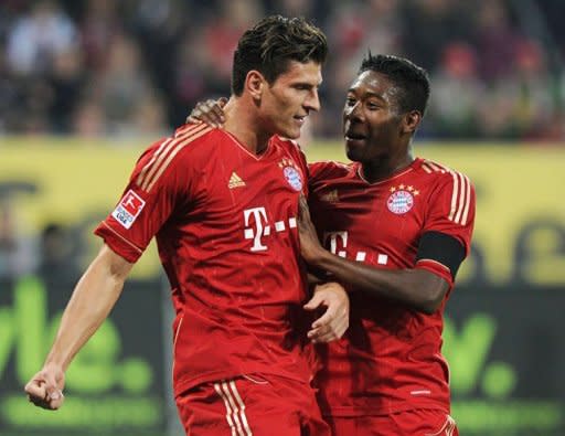 Bayern Munich's striker Mario Gomez (L) and his Austrian teammate midfielder David Alaba celebrate scoring during the German first division Bundesliga football match FC Augsburg vs FC Bayern Munich in the southern German city of Augsburg. Ten-man Bayern Munich went five points clear again at the top of the German league on Sunday as Gomez scored his 20th goal of the season in a 2-1 win