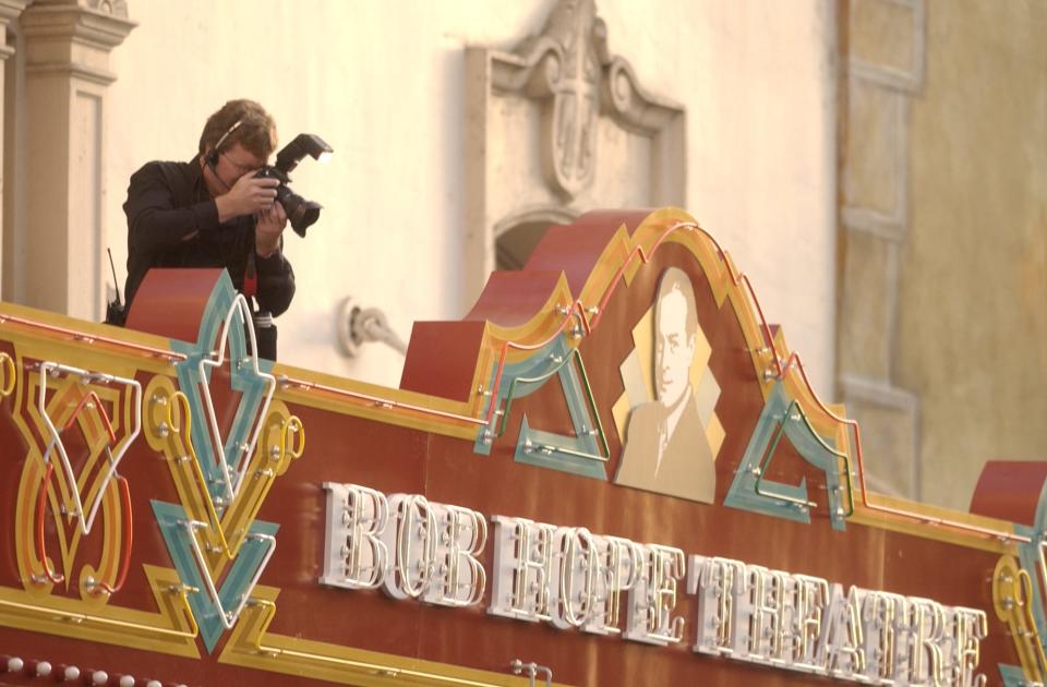 Fox.Reopens.91.JPG,  Record photo by CLIFFORD OTO Photographer Tim Ulmer shoots from the marquee sign at the grand reopening of the Bob Hope Theater in downtown Stockton. 6:52:24 PM, 09/18/2004, NIKON D1H, {aperature}, 1/200, 500, LOW,  300, SHADE ORG XMIT: MER2013031814483019