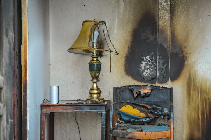 empty burnt chair next to lamp