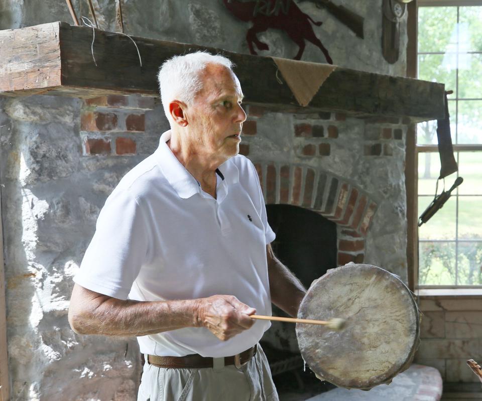 Steve Slifko, owner of Red Run Bison Farm, hits drum made with bison skin at his farm in Marshallville.