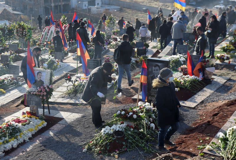 People visit a military cemetery on the day of the Armenian nationwide mourning in Yerevan