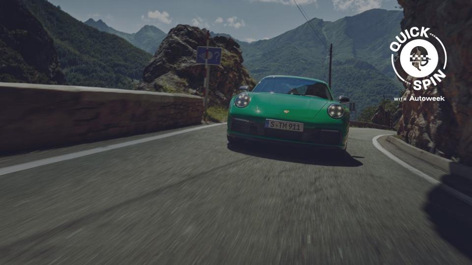 a green car driving on a road