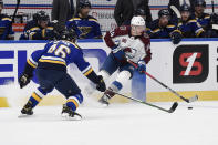 St. Louis Blues' Jake Walman (46) defends against Colorado Avalanche's Jacob MacDonald (34) during the first period of an NHL hockey game on Wednesday, April 14, 2021, in St. Louis. (AP Photo/Joe Puetz)