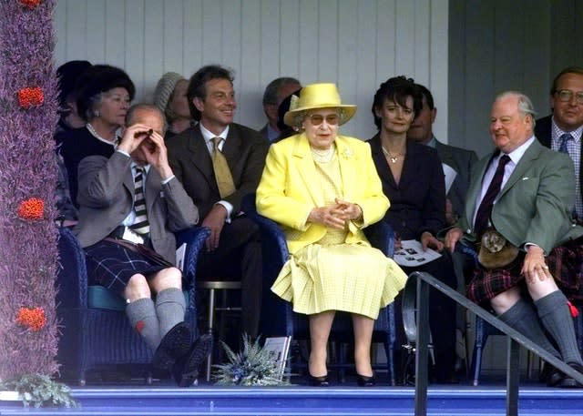 Tony Blair and the Queen watch the games at the Braemar Gathering in 1999