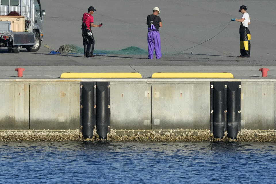 Fishermen arrange their fishing net at Ukedo fishing port in Namie town, northeastern Japan, on Thursday, Aug. 24, 2023, near the Fukushima Daiichi nuclear power plant, damaged by a massive March 11, 2011, earthquake and tsunami. The Fukushima Daiichi nuclear power plant will start releasing treated and diluted radioactive wastewater into the Pacific Ocean as early as Thursday. (AP Photo/Eugene Hoshiko)