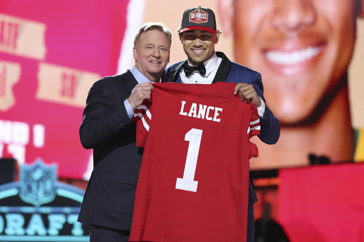 North Dakota State quarterback Trey Lance, right, holds a team jersey with NFL Commissioner Roger Goodell after the San Francisco 49ers selected Lance with the 3rd pick in the first round of the NFL football draft Thursday April 29, 2021, in Cleveland. (AP Photo/Gregory Payan)