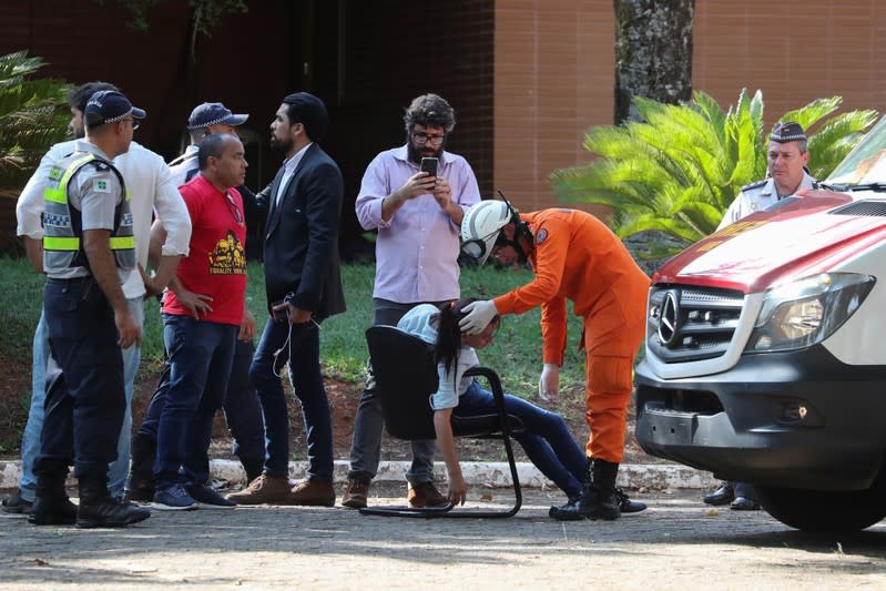 A woman receives medical attention on the grounds of the Venezuelan embassy in Brasilia