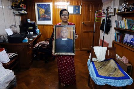 Tin Tin Aye, the wife of Ko Ni, holds a photo of her late husband at their house in Yangon, Myanmar, October 4, 2018. REUTERS/Ann Wang/Files