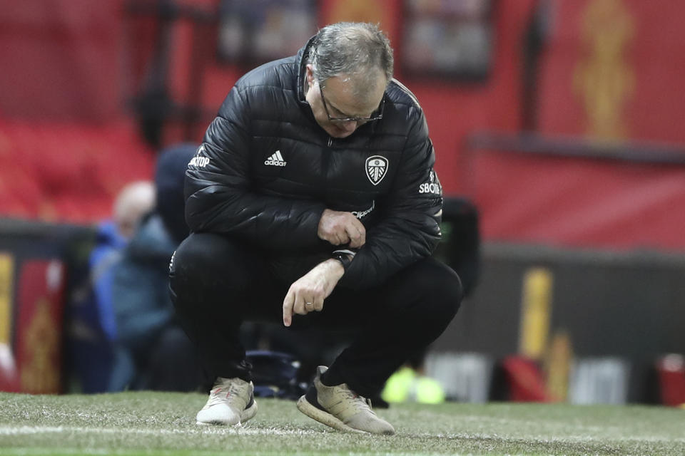Leeds United's head coach Marcelo Bielsa looks at his watch during an English Premier League soccer match between Manchester United and Leeds United at the Old Trafford stadium in Manchester, England, Sunday Dec. 20, 2020. (Nick Potts/Pool via AP)