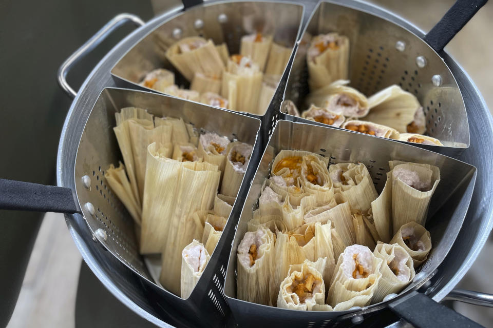 Roasted turkey tamales with cranberry-infused masa, the entree of a contemporary Indigenous meal prepared by Ketapanen Kitchen executive chef Jessica Pamonicutt, are ready to be served to seniors at the American Indian Center of Chicago, on Aug. 3, 2022. (Claire Savage/Report for America via AP)
