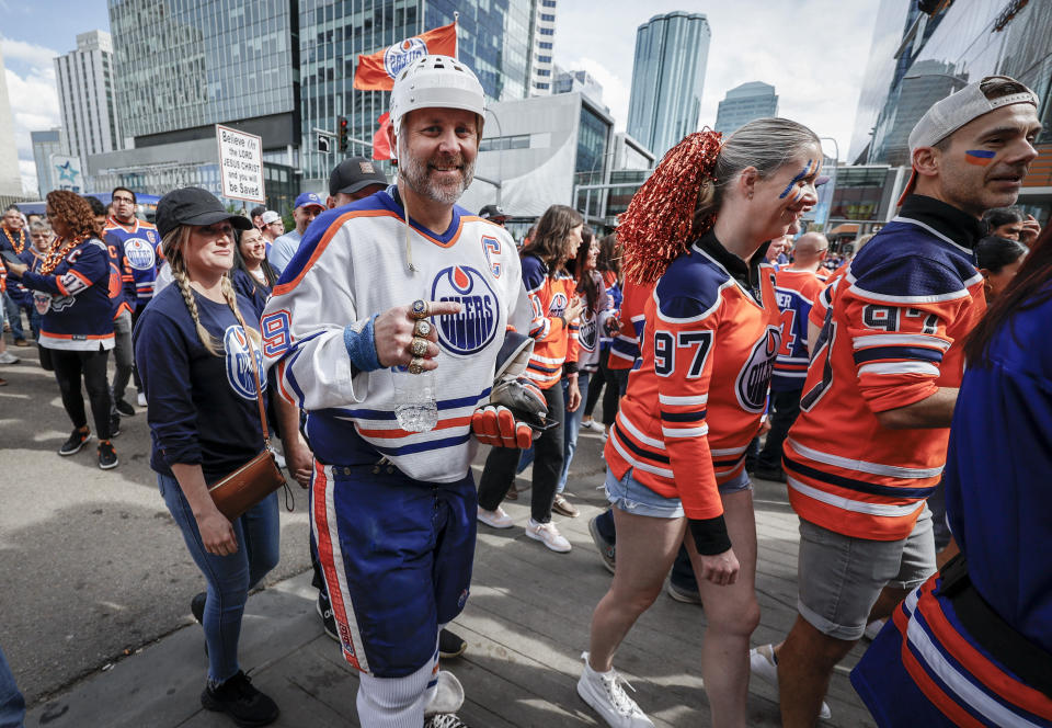 Edmonton Oilers fans arrive for Game 4 of the NHL hockey Stanley Cup Final between the Oilers and the Florida Panthers, Saturday, June 15, 2024, in Edmonton, Alberta. (Jeff McIntosh/The Canadian Press via AP)