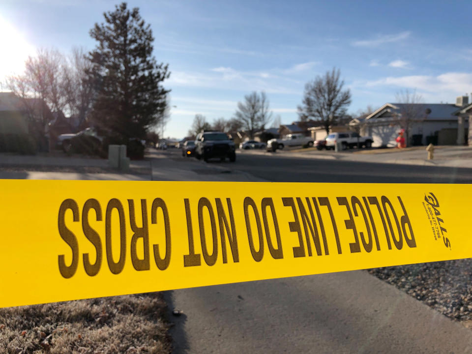 Police have a residential street cordoned off as detectives investigate the deaths of four people found Christmas Day inside a home in Rio Rancho, N.M., on Thursday, Dec. 26, 2019. All of the victims appeared to have suffered gunshot wounds, police said in a statement posted on Facebook. Police did not identify the victims or say whether a suspect or suspects have been identified. (AP Photo/Susan Montoya Bryan)