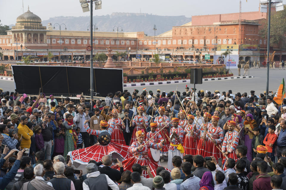 Folk dancers perform for the crowd before a road show by French President Emmanuel Macron and Indian Prime Minister Narendra Modi began in Jaipur, Rajasthan, India, Thursday, Jan. 25, 2024. Macron will be the chief guest at India's annual republic day parade in New Delhi on Friday. (AP Photo/ Deepak Sharma)