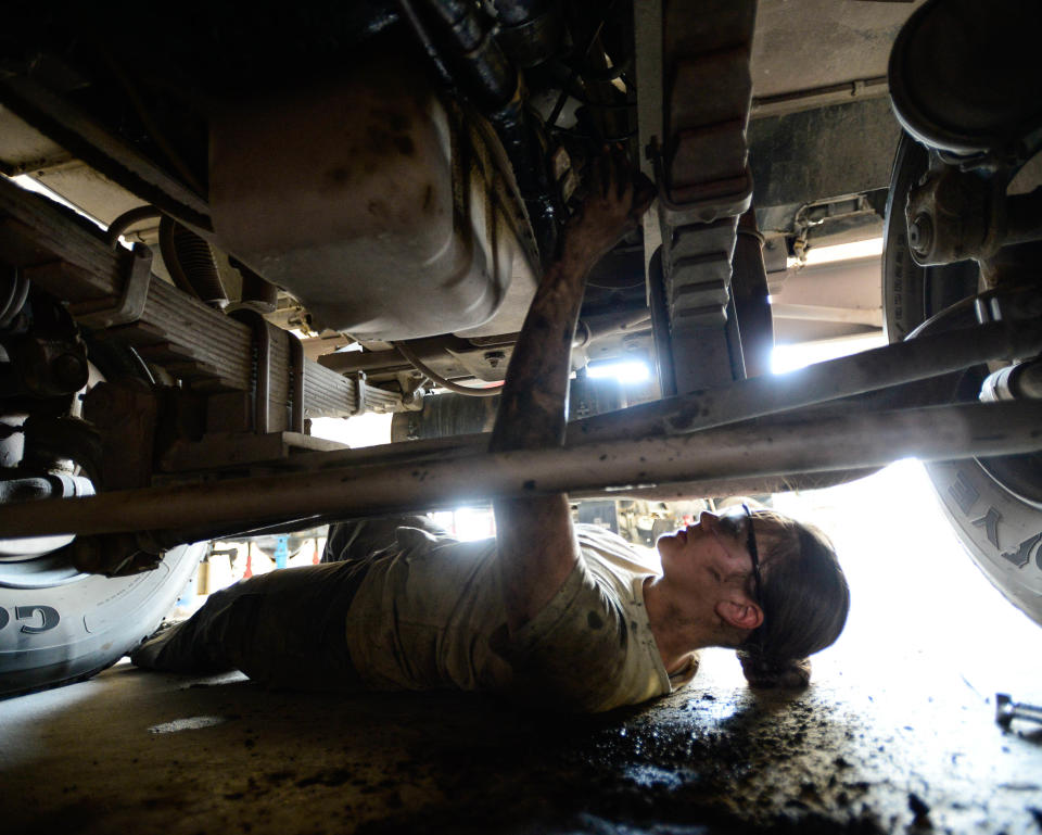 Staff Sgt. Saber Barrera, with 386th Expeditionary Logistics Readiness Squadron firetruck and refueling maintenance, works with a co-worker to replace an engine starter in Southwest Asia, Aug. 27, 2015. The Airmen support Operation Inherent Resolve, which is intended to reflect the deep commitment of the U.S. and partner nations in the region and around the globe to eliminate the Islamic State of Iraq and the Levant terrorist group and the threat imposed on Iraq.