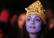 LEICESTER, UNITED KINGDOM - NOVEMBER 13: Dancer Vimi Solanki waits to perform on stage as Lord Krishna during the Hindu festival of Diwali on November 13, 2012 in Leicester, United Kingdom. Up to 35,000 people attended the Diwali festival of light in Leicester's Golden Mile in the heart of the city's asian community. The festival is an opportunity for Hindus to honour Lakshmi, the goddess of wealth and other gods. Leicester's celebrations are one of the biggest in the world outside India. Sikhs and Jains also celebrate Diwali. (Photo by Christopher Furlong/Getty Images)