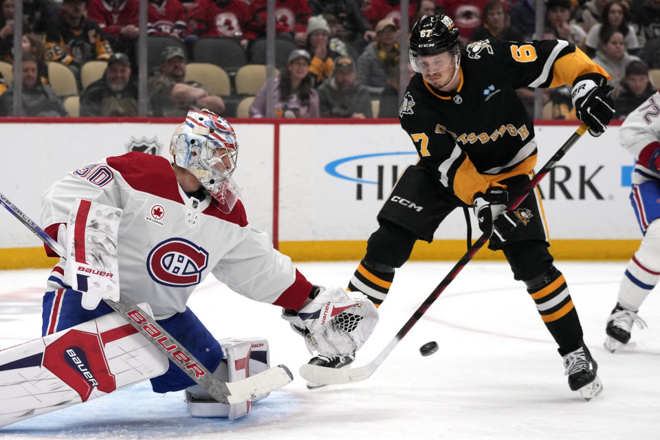 Pittsburgh Penguins' Rickard Rakell (67) can't redirect a shot in front of Montreal Canadiens goaltender Cayden Primeau during the second period of an NHL hockey game in Pittsburgh, Thursday, Feb. 22, 2024. (AP Photo/Gene J. Puskar)