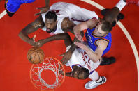 Los Angeles Clippers center DeAndre Jordan, top, shoots as Oklahoma City Thunder forward Domantas Sabonis, right, of Lithuania, defends and forward Luc Mbah a Moute, of Cameroon, watches during the first half of an NBA basketball game, Monday, Jan. 16, 2017, in Los Angeles. (AP Photo/Mark J. Terrill)