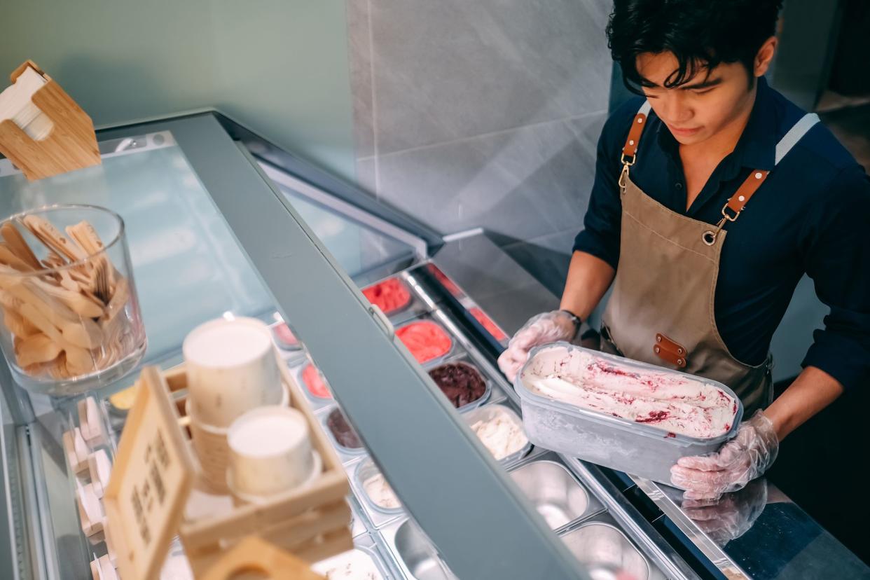 male adult serving ice cream in gelato cafe