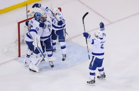 May 29, 2015; New York, NY, USA; Tampa Bay Lightning goalie Ben Bishop (30) celebrates with right wing Nikita Kucherov (86) , center Tyler Johnson (9) and center Steven Stamkos (91) after defeating the New York Rangers in game seven of the Eastern Conference Final of the 2015 Stanley Cup Playoffs at Madison Square Garden. Adam Hunger-USA TODAY Sports