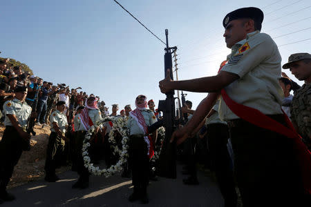 Guard of honor and relatives of Sergeant Hisham Aqarbeh, of the anti-terrorist unit, who was killed during an attack yesterday, attend his funeral in Birayn in the city of Zarqa, Jordan, August 12, 2018.REUTERS/Muhammad Hamed