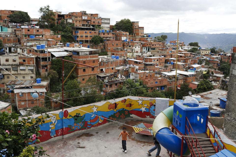 Children play at a playground in the Jose Felix Ribas Commune in Caracas November 26, 2013. To match Special Report VENEZUELA-COMMUNES/ Picture taken on November 26, 2013. REUTERS/Carlos Garcia Rawlins (VENEZUELA - Tags: POLITICS)