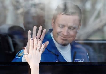 The International Space Station (ISS) crew member Jack Fischer of the U.S. waves from a bus before leaving for pre-flight preparation at the Baikonur cosmodrome, Kazakhstan, April 20, 2017. REUTERS/Shamil Zhumatov