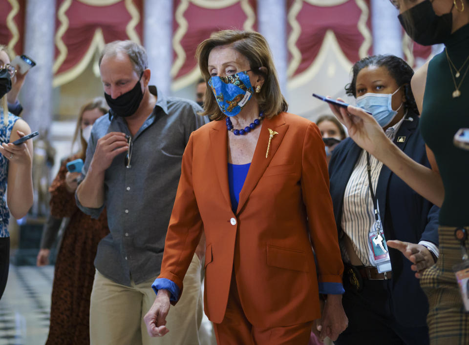 House Speaker Nancy Pelosi, D-Calif., walks to the chamber for a vote, joined at left by actor Woody Harrelson, at the Capitol in Washington, Wednesday, Sept. 29, 2021. (AP Photo/J. Scott Applewhite)