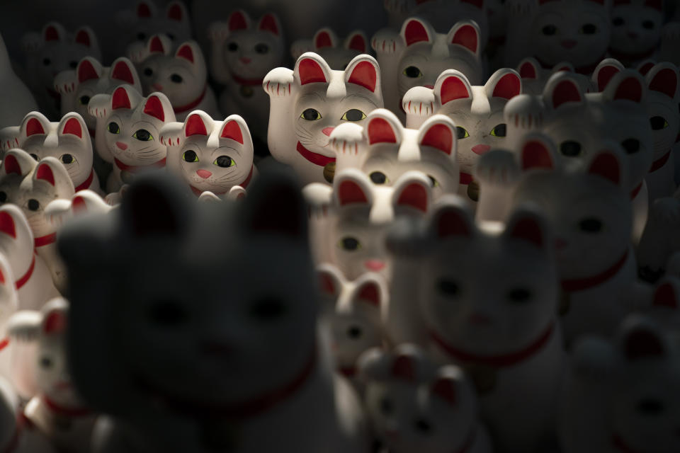 In this June 25, 2019, photo, beckoning cat figurines are on display at Gotokuji Temple in Tokyo. According to a centuries-old legend provided by the temple, Gotokuji, a Buddhist temple located in the quiet neighborhood of Setagaya, is the birthplace of beckoning cats, the famous cat figurines that are widely believed to bring good luck and prosperity to home and businesses. Some visitors come just to snap a few photos, while others make a trip to the temple to pray and make wishes. (AP Photo/Jae C. Hong)