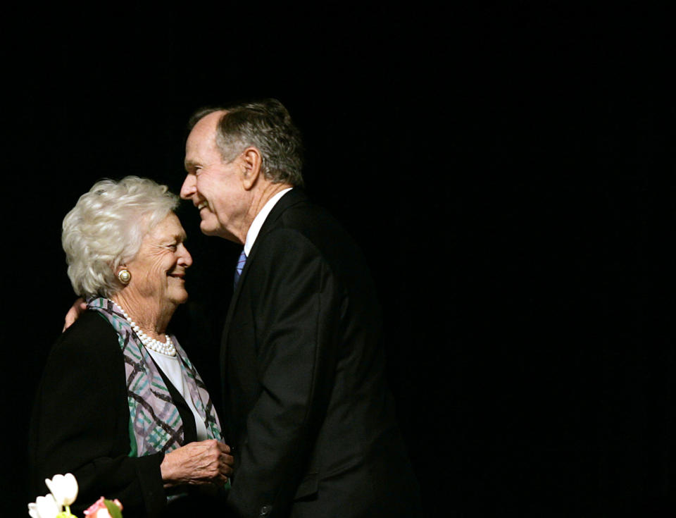 In this May 3, 2006 photo, former President George H.W. Bush embraces former first lady Barbara Bush after she introduced him at the Genesis Women's Shelter Mother's Day Luncheon in Dallas. The Bushes, who have had the longest marriage of any presidential couple in American history, were both hospitalized this week in Houston, where the former president is being treated for pneumonia and his wife for bronchitis. (AP Photo/Tony Gutierrez)