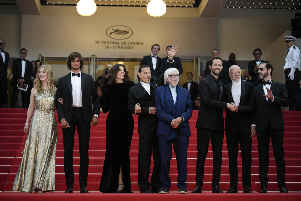 Pauline Pollmann, from left, Diego Le Fur, director Maiwenn, Johnny Depp, Pierre Richard, Benjamin Lavernhe, Pascal Greggory, and Melvil Poupaud pose for photographers upon arrival at the opening ceremony and the premiere of the film 'Jeanne du Barry' at the 76th international film festival, Cannes, southern France, Tuesday, May 16, 2023. (AP Photo/Daniel Cole)