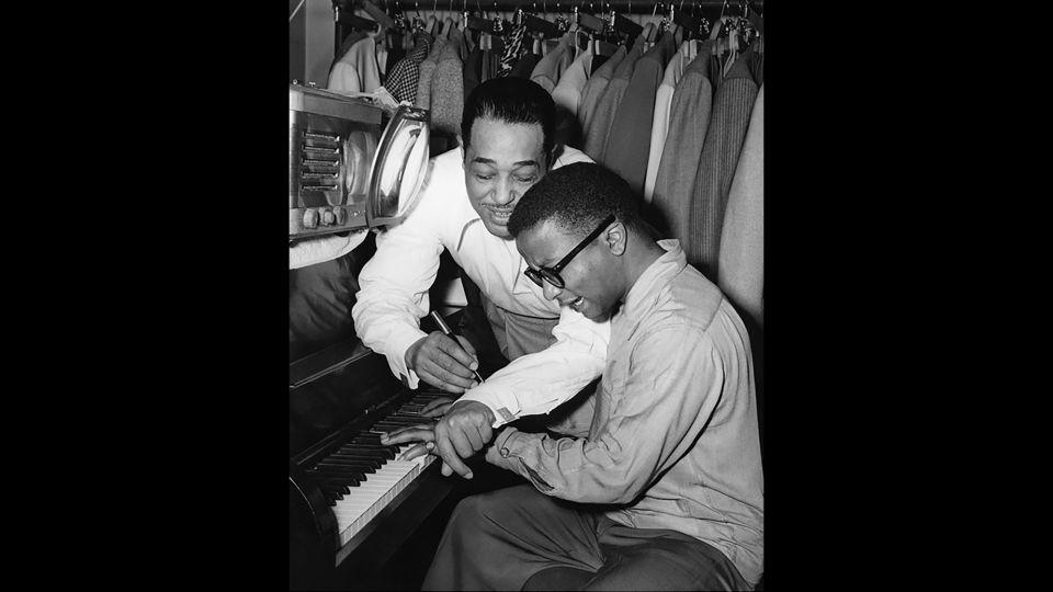 Composer and bandleader Duke Ellington hovers over fellow pianist and band member Billy Strayhorn in this 1948 photograph. - Courtesy of Limited Runs