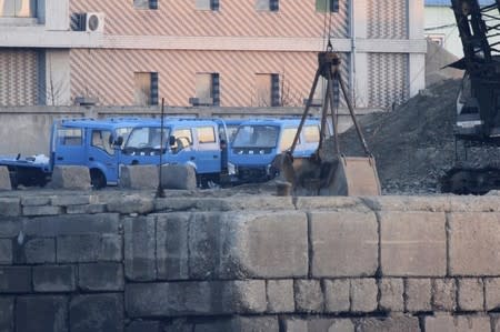 Trucks are parked next to a pile of coal on the bank of the Yalu River in Sinuiju, opposite the Chinese border city of Dandong, March 14, 2016. REUTERS/Jacky Chen