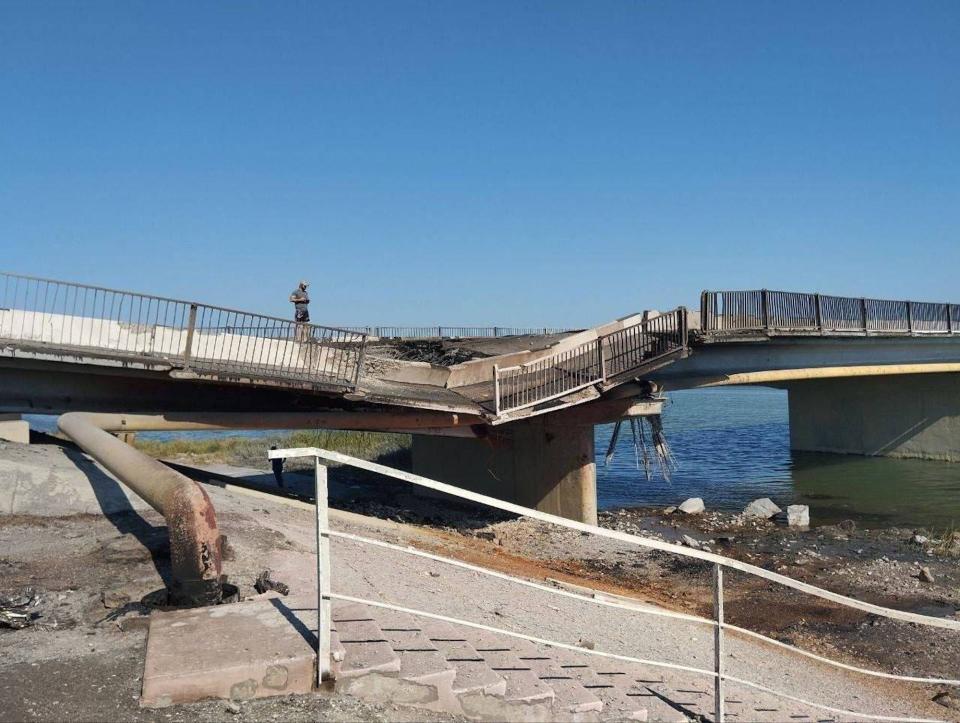 A side-on view of a cratered bridge in Crimea, as Ukraine announces a strike with a Storm Shadow missile on August 6, 2023