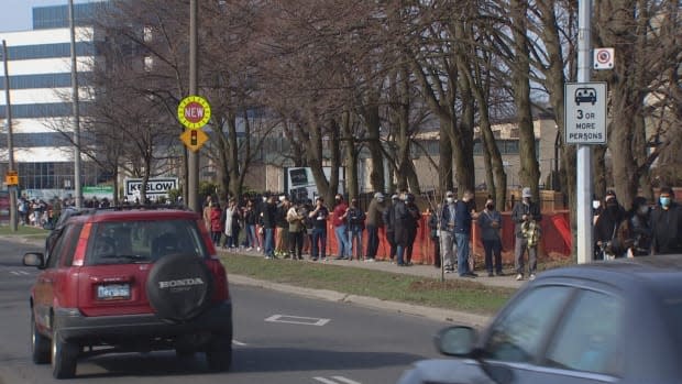 The lineup for the 1,000 shots available stretched down the block from a pop-up vaccination clinic at Masjid Darussalam Thorncliffe Mosque. It's one of 111 neighbourhoods in Toronto that have been disproportionately hard hit by the pandemic.  (Yanjun Li/CBC - image credit)