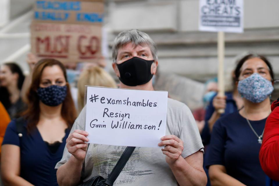 People including students hold placards on Whitehall outside Downing Street in London on August 14, 2020 as they protest against the downgrading of A-level results. - The British government faced criticism after education officials downgraded more than a third of pupils' final grades in a system devised after the coronavirus pandemic led to cancelled exams. (Photo by Tolga Akmen / AFP) (Photo by TOLGA AKMEN/AFP via Getty Images)