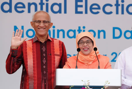 Singapore's President-elect Halimah Yacob and her husband Mohammed Abdullah Alhabshee address supporters before leaving the nomination centre in Singapore September 13, 2017. REUTERS/Edgar Su